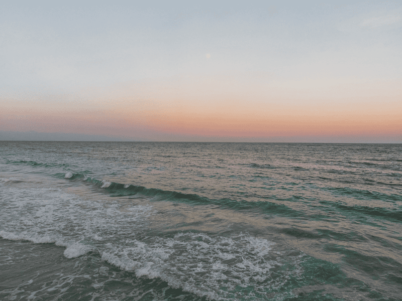 calm beach at sunset representing stress management