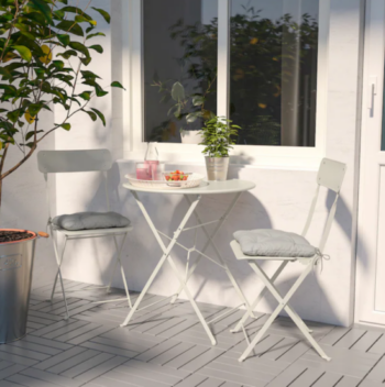 table and chairs in the sunshine plant and drinks on the table spring refresh