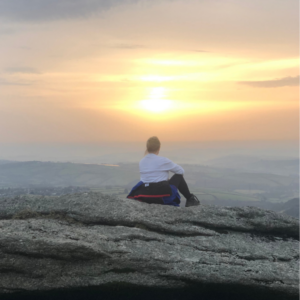 image of me sitting overlooking Dartmoor as the sun rises reflecting on being too kind.