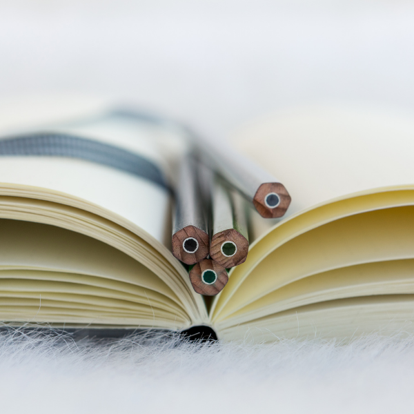 image of pencils and notebook indicating taking time to book the appointments thus recharge the batteries