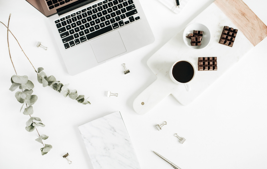 open laptop flatlap with coffee and chocolate featuring work - start your morning at the desk ready to be productive