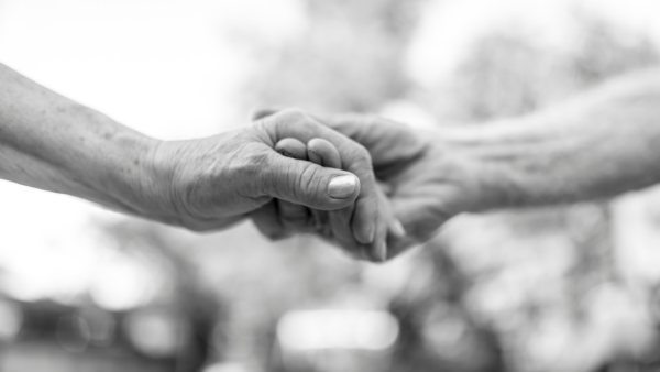 B&W image of couple holding hands