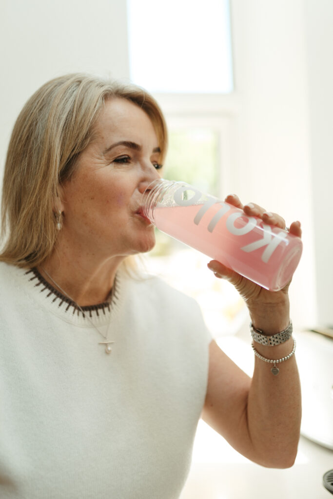 Claire drinking a kollo drink at home